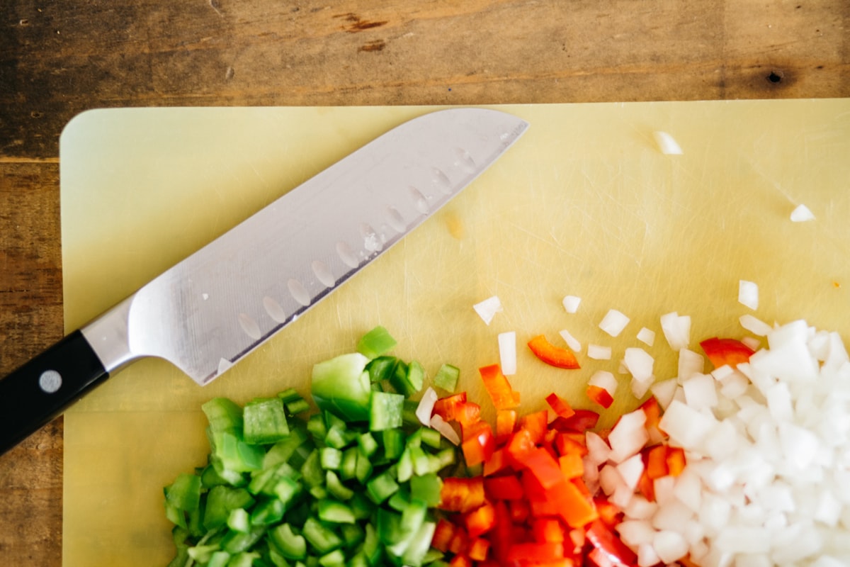 Student confidently using proper knife techniques in kitchen